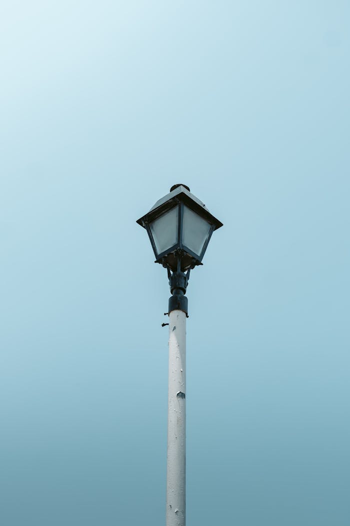 A classic street lamp set against a serene blue sky in Tlacotalpan, Mexico.
