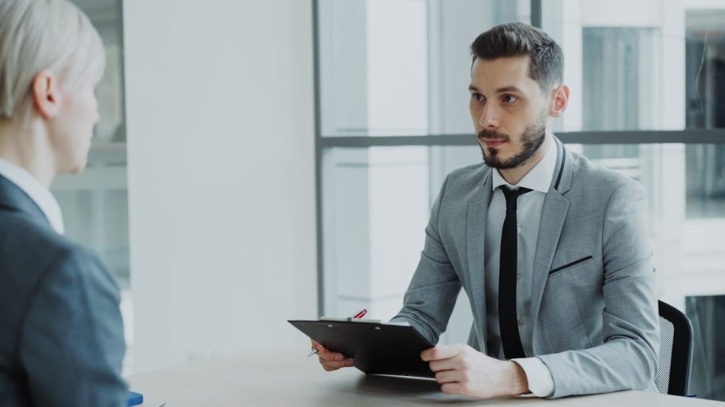 Two business professionals engaged in a meeting in a modern office environment.